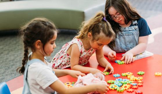 Young girls playing with puzzle pieces