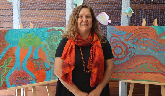 Saretta Fielding standing in front of her library card artwork