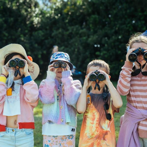 Group of children looking through binoculars