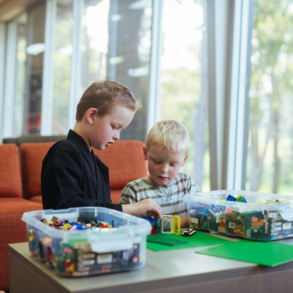 Two young boys playing with lego