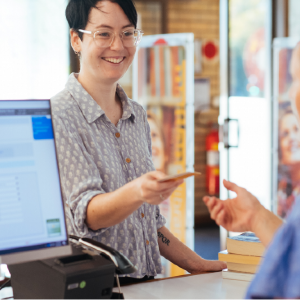 Handing over a library card for a reservation