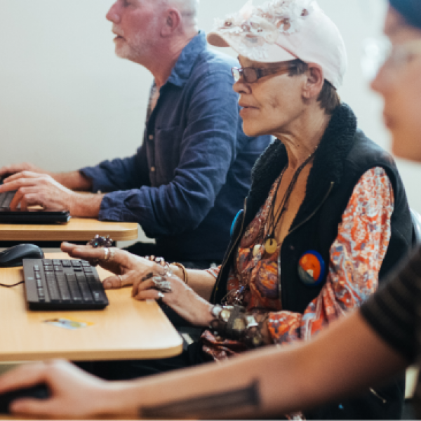 Three people sitting at computers