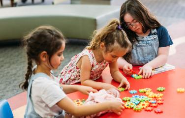 Young girls playing with puzzle pieces